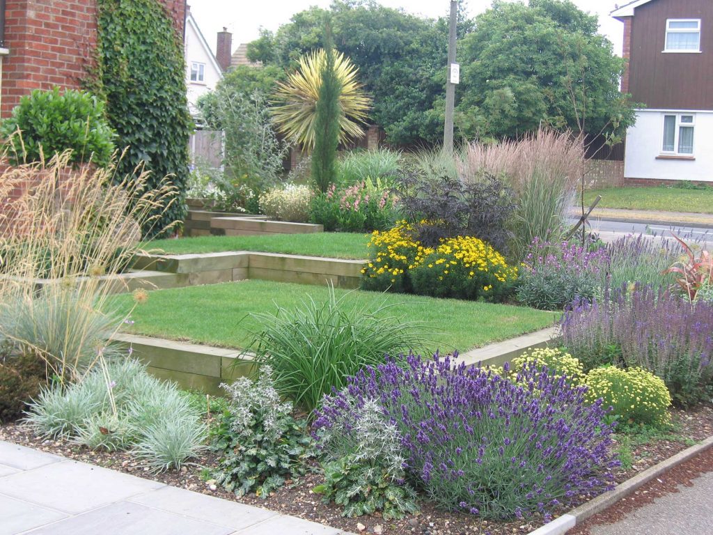 perfect lawn surrounded by herbaceous borders in the front garden of a modern property