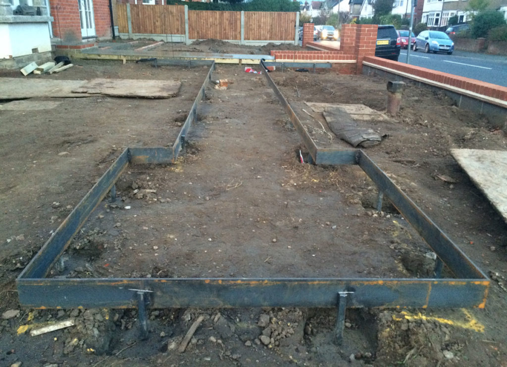 metal edging being installed in a rectangular shape as part of a victorian style garden makeover