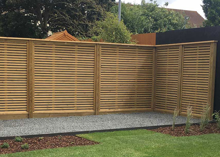 timber fence with lateral slats to form a screen