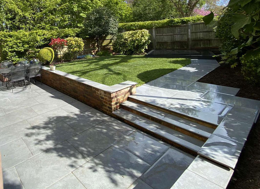 porcelain patio with steps leading to path and lawn