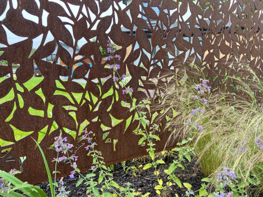 metal garden screen with laser cut leaf pattern