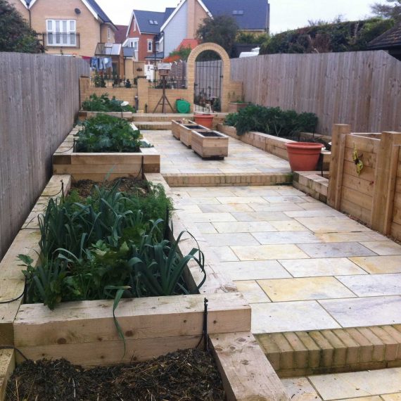 vegetable garden built on a slope with raised beds, paving and steps