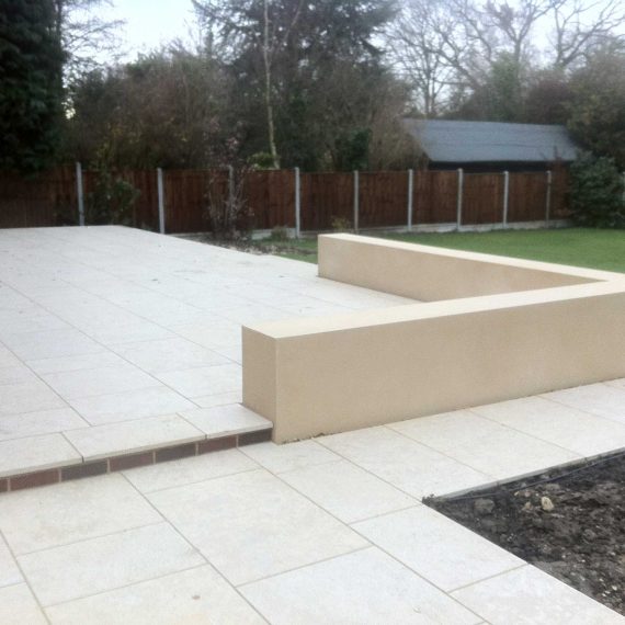 white porcelain patio with low wall doubling as built in seating