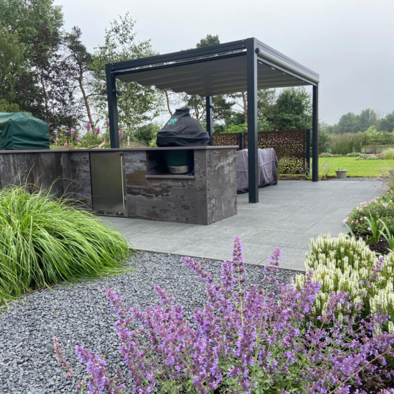 outdoor kitchen with pergola, seating area and planting