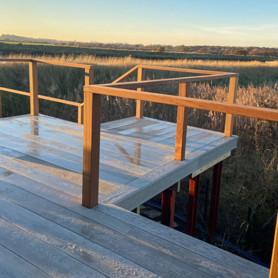 view from raised deck over wetland scene at sunset