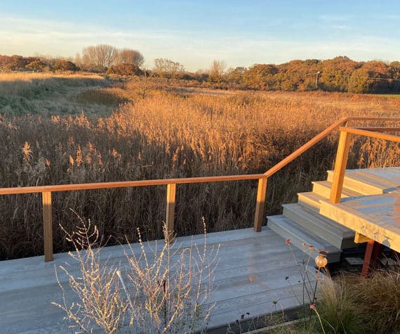 composite decking boardwalk with views across autumn wetland scene