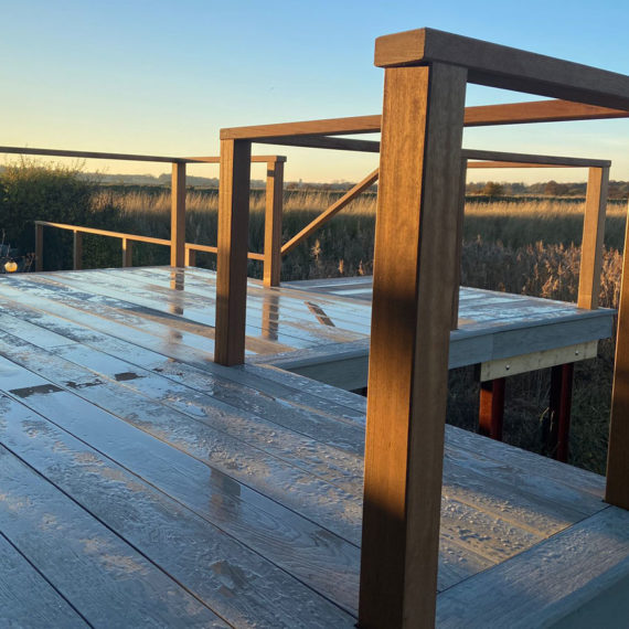 Natural timber handrail for composite decking platform
