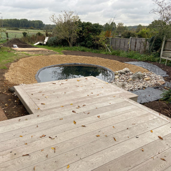 large composite decking steps leading to newly built pond