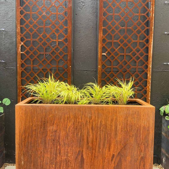 corten steel rectangular planter with zesty green grasses and corten decorative screens