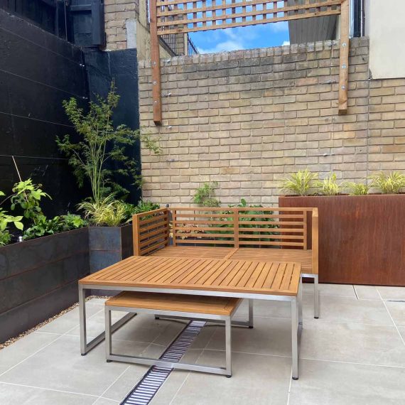 modern courtyard garden with porcelain paving and attractive slot drains