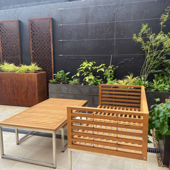 stylish outdoor furniture in a courtyard garden with beautifully planted containers