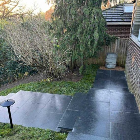 garden path in black granite with flight of garden stairs leading off to the left