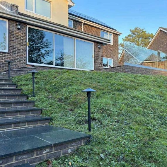flight of garden steps with grassy bank and attractive light fittings beside