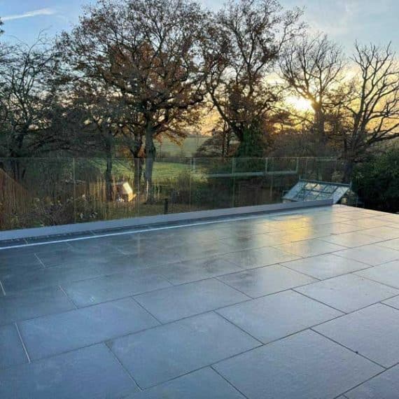 black granite patio with view of the sun setting over Essex countryside